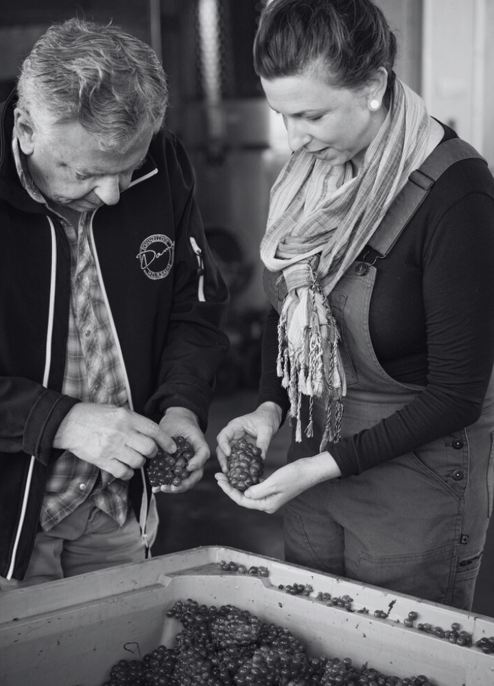 Kathryn and Chris holding grapes